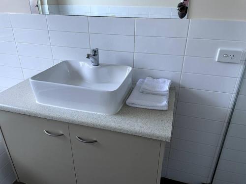 a bathroom with a sink and towels on a counter at Tasha's Apartments in Angle Park - N38 in Woodville