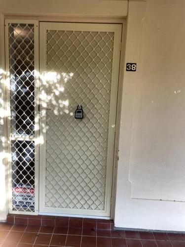 a door with a glass gate in a room at Tasha's Apartments in Angle Park - N38 in Woodville