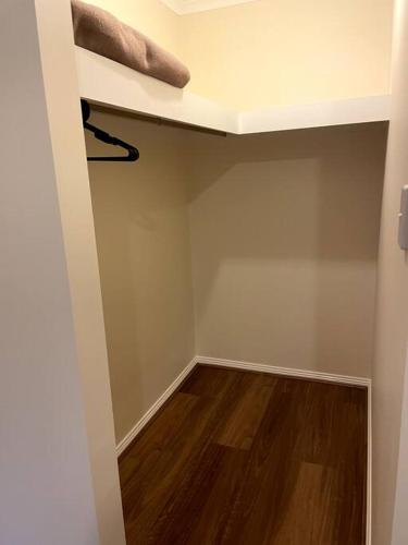 an empty room with a closet with a wooden floor at Tasha's Apartments in Angle Park - N38 in Woodville