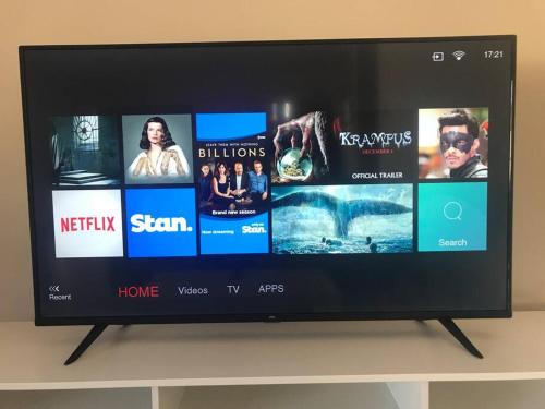 a flat screen tv sitting on top of a shelf at Tasha's Apartments in Angle Park - N38 in Woodville