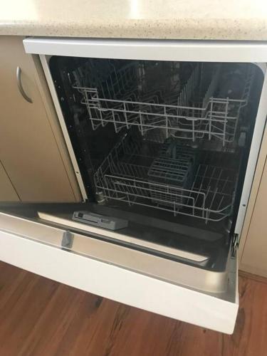 an oven with a dish rack inside of it at Tasha's Apartments in Angle Park - N38 in Woodville
