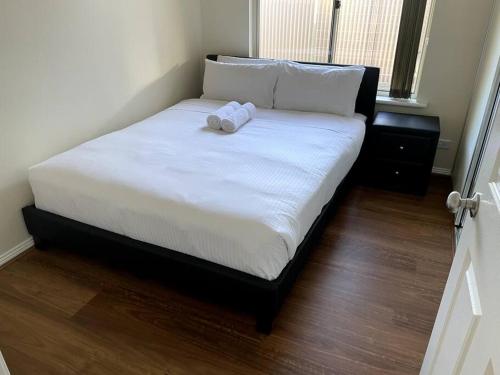 a bed with a stuffed animal sitting on top of it at Tasha's Apartments in Angle Park - N38 in Woodville
