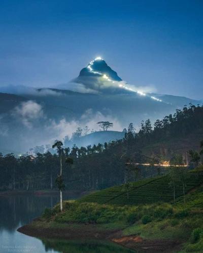 a mountain with a beam of light on top of it at KPL Holiday Homes in Hatton