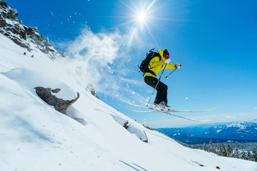 a skier jumping off of a snow covered mountain at Summit Lofts Boutique Hotel in Mount Shasta