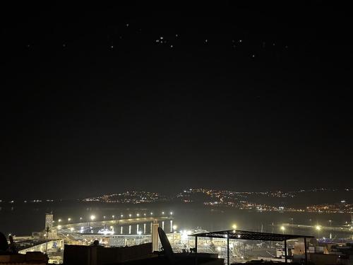 a view of a city at night with lights at chez Abdou house with ocean view in Tangier