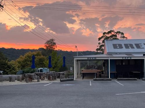 a gas station with a bench in a parking lot at The Bay Rose in Forrest