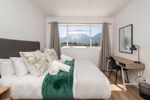 sypialnia z łóżkiem z biurkiem i oknem w obiekcie Claremont Apartment With Three Bedrooms w Kapsztadzie