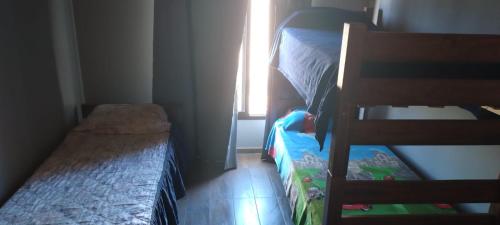 a small bedroom with a bunk bed and a window at casa necochea in Necochea