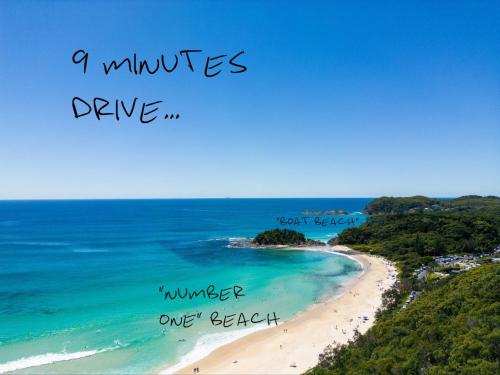 a picture of a beach with the words a minutes drive and a winter one breath at THE MAINSTAY Farmstay - book one of 4 houses or all 4, minutes to Seal Rocks! in Neranie