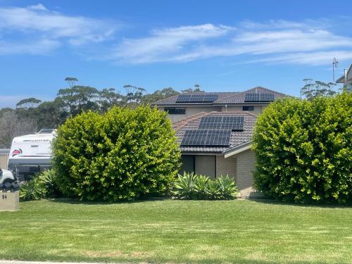 a house with solar panels on the roof at 2 SeaShells in Ulladulla