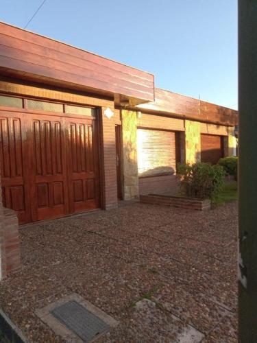 a house with two garage doors and a driveway at CASA ELENA in Mar del Plata