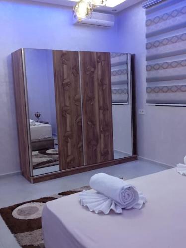 a bathroom with a large mirror and a white towel at Private Villa with private Chef optional in Marrakesh