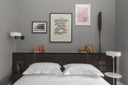 a bedroom with a bed with two white pillows at The Laslett in London