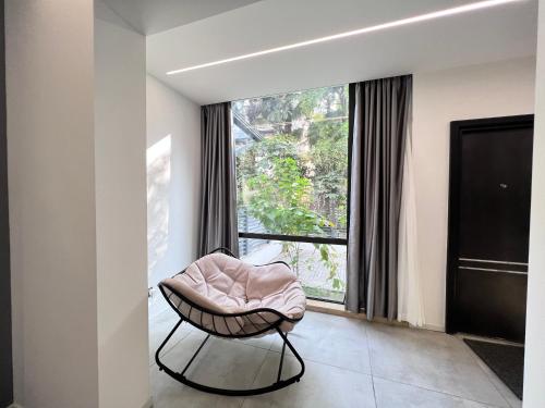 a room with a chair in front of a window at Shanghai World Expo Villa B&B - Near Lujiazui in Shanghai