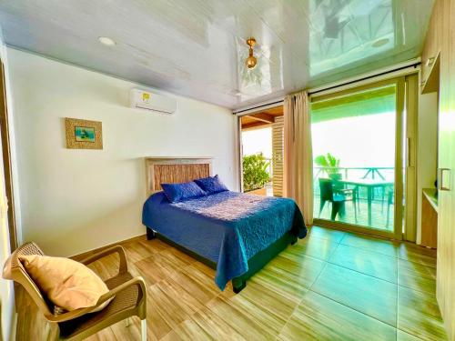 a bedroom with a bed and a balcony at Caribbean Escape Lodge in San Silvestre