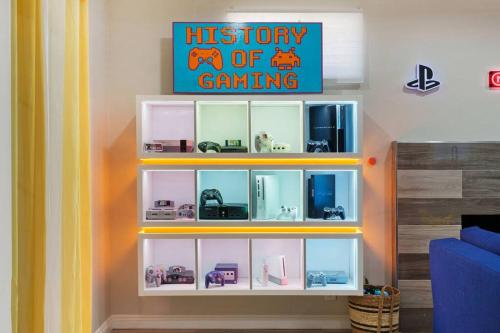 a room with a white shelf with toy cars on it at Gamers Getaway: Arcade, Theater, Racing, And More! in Stanton