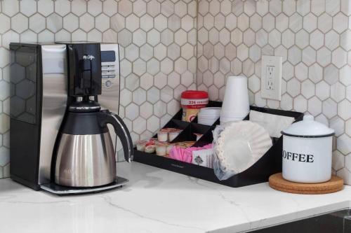 a kitchen counter with a coffee maker on a counter top at Gamers Getaway: Arcade, Theater, Racing, And More! in Stanton