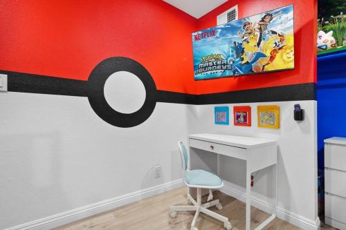 a room with a desk and a car on the wall at Gamers Getaway: Arcade, Theater, Racing, And More! in Stanton