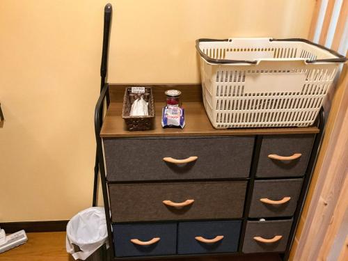 a dresser with a basket on top of it at minpaku hotaru - Vacation STAY 65549v in Takamatsu