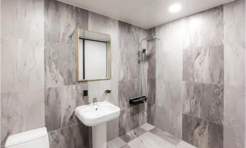 a bathroom with a white sink and a mirror at On & Off Hotel Bupyeong in Incheon