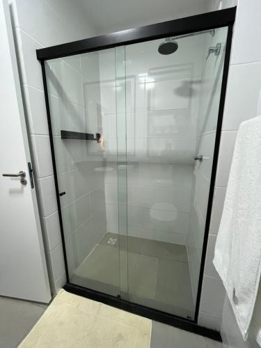a glass shower door in a bathroom at Studio Estilo Industrial +Espaço in Mossoró