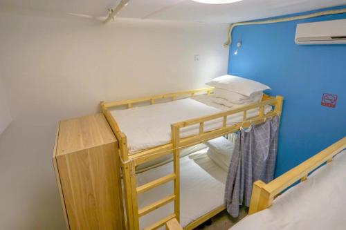 a small room with two bunk beds in it at Harbin Hash International Youth Hostel Harbin West Station in Harbin