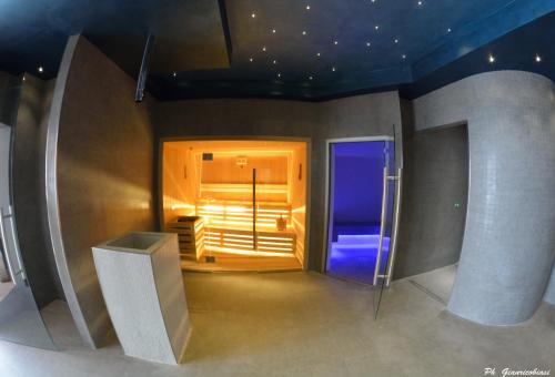a room with a blue lighted door in a room at Villa Clorè Hotel & Spa in Lama Mocogno