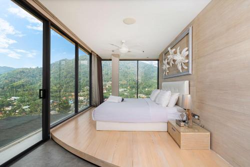 a bedroom with a white bed and large windows at Serenity and Modern Art - Open Hill View 3BR Natural Park Villa 1 in Kamala Beach