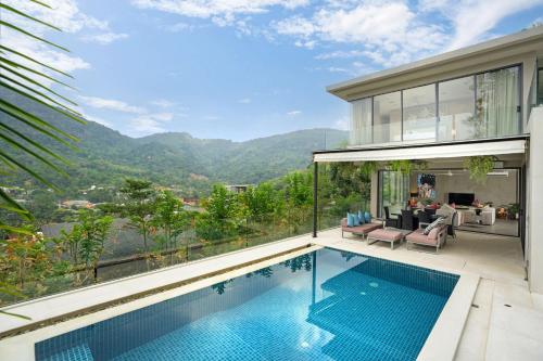 a house with a swimming pool with a view at Serenity and Modern Art - Open Hill View 3BR Natural Park Villa 1 in Kamala Beach