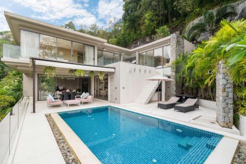an exterior view of a house with a swimming pool at Serenity and Modern Art - Open Hill View 3BR Natural Park Villa 1 in Kamala Beach