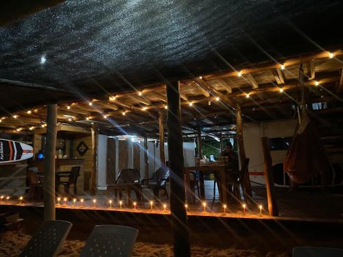 a patio with lights and a table with chairs at Posada Shekinah Barú in Playa Blanca