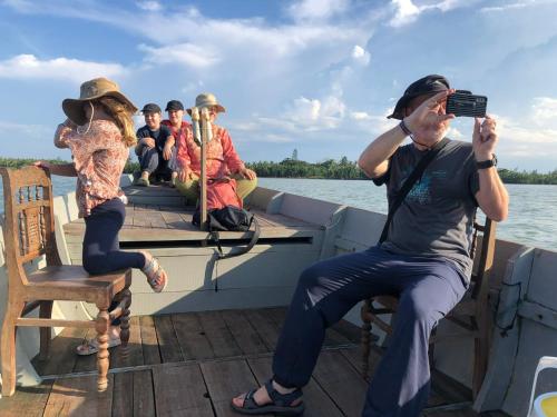 a group of people on a boat on the water at Hoi An Mercy homestay in Hiếu Nhơn