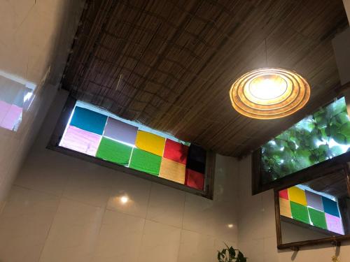 a room with two windows with rainbow colors at Hoi An Mercy homestay in Hiếu Nhơn