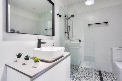 a white bathroom with a sink and a shower at 3 Bedroom House Chippendale Near the Center 2 E-Bikes Included in Sydney