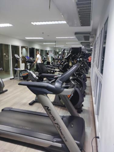 a gym with a lot of cardio machines at The Prio Condo Chiang Mai in Chiang Mai