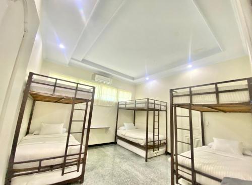 two bunk beds in a room with white walls at Sentosa Lodge in Kampungdurian