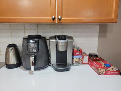 a coffeemaker sitting on a kitchen counter next to a box at King Luxury Ensuite Private Room in Toronto