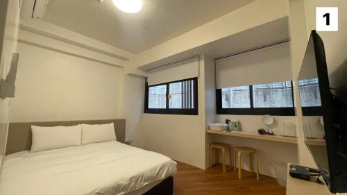Llit o llits en una habitació de FUNDI Hotel