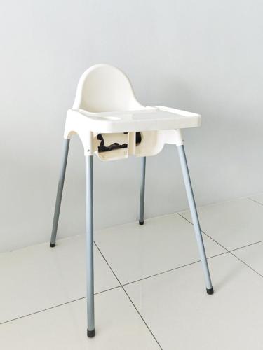 a white chair with a black cat sitting on it at Manhattan Condo Ipoh Waterpark PoolView FREE Carpark & Netflix by PLY Home in Ipoh