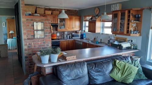 a kitchen with a counter and a couch in a room at Betty's Bay Holiday home in Clareport