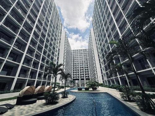 a pool in the middle of two tall buildings at Briannas Crib in Manila