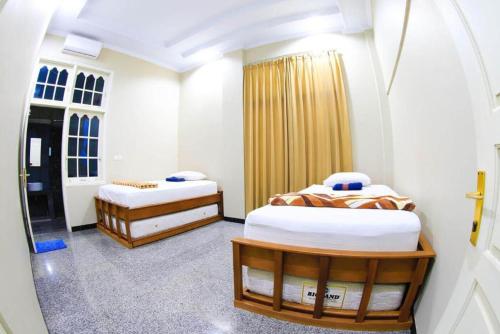 Ένα ή περισσότερα κρεβάτια σε δωμάτιο στο Sentosa Lodge