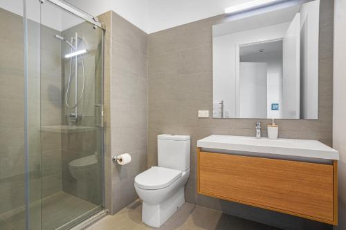 a bathroom with a toilet and a sink and a shower at Urban Vista - Christchurch Holiday Home in Christchurch