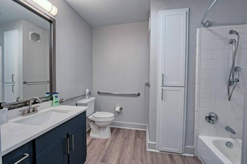 a bathroom with a sink and a toilet and a shower at Stylish and Cozy in Dallas Downtown in Dallas