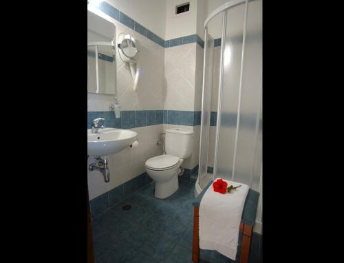 y baño con aseo y lavamanos. en Lato hotel, en Agios Nikolaos