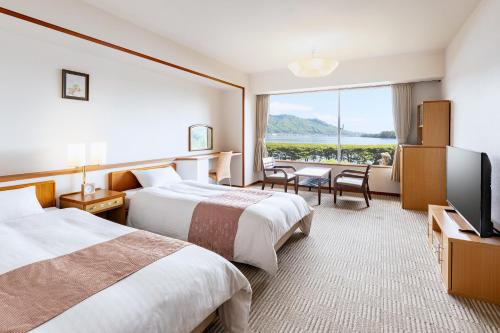 Voodi või voodid majutusasutuse Amano Hashidate Hotel toas