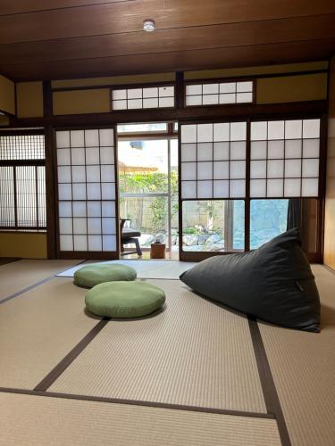 two pillows on a rug in a room with windows at 【天王寺駅まで電車4分】庭園付き一軒家ー杏 in Osaka