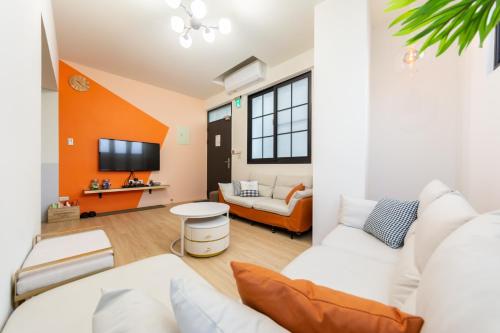a living room with a couch and a tv at Nan Yi Style in Tainan