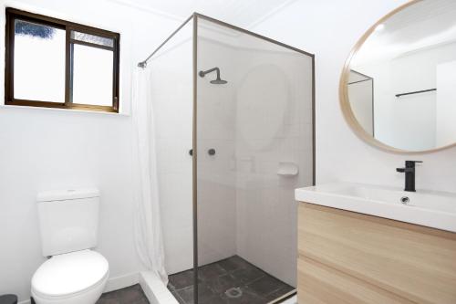 a bathroom with a shower and a toilet and a sink at Hawks Nest Hideaway in Hawks Nest