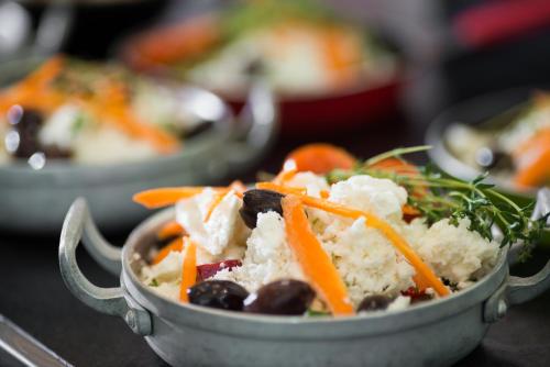 a bowl of food with vegetables and rice at Leonardo Plaza Haifa in Haifa